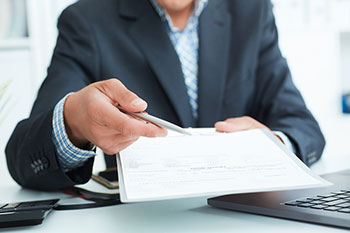 Man in a Suit Offers to Sign a Contract